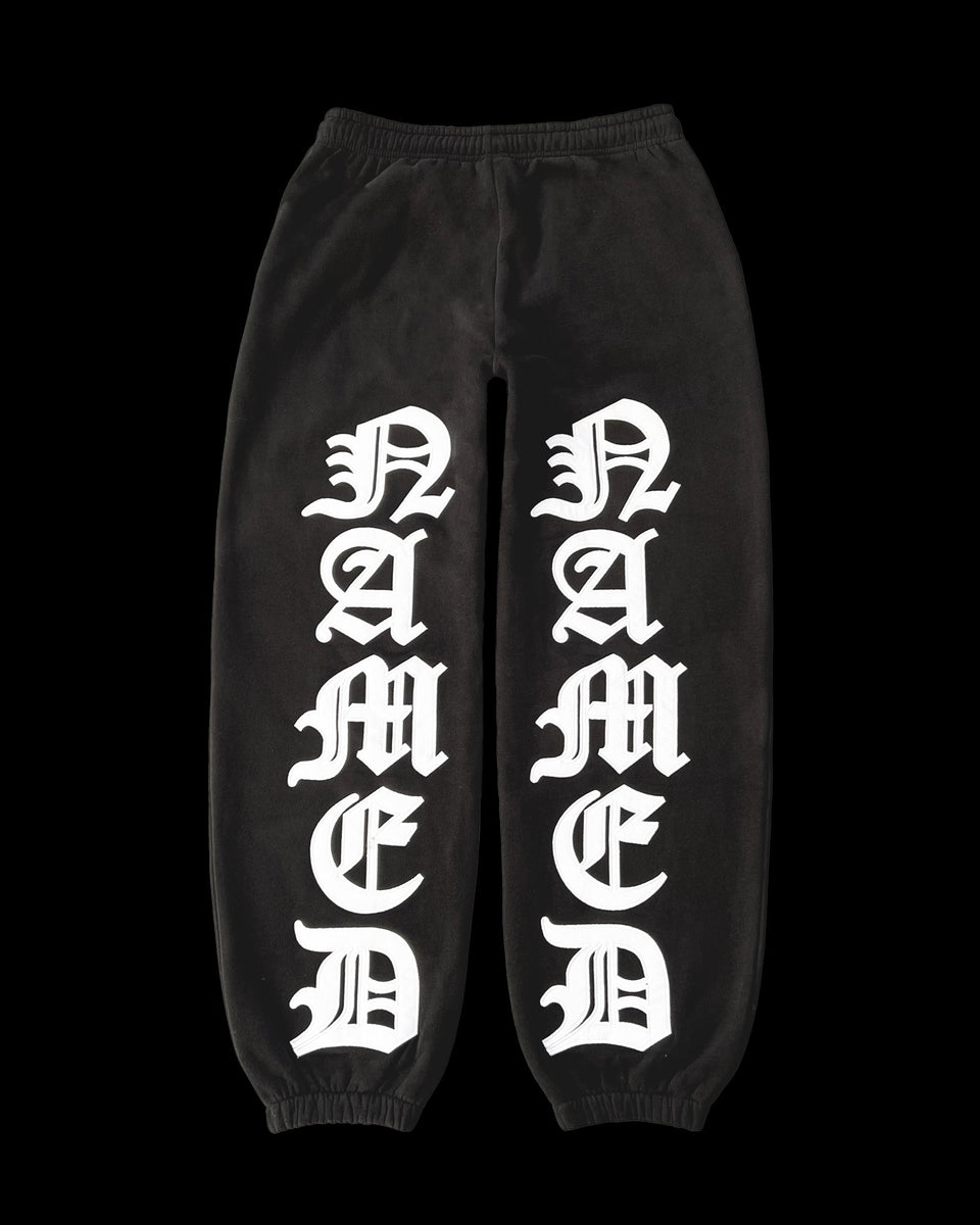 MISSION SWEATPANTS BLACK by NAMED COLLECTIVE® featuring large white Gothic NAMED print down both legs.