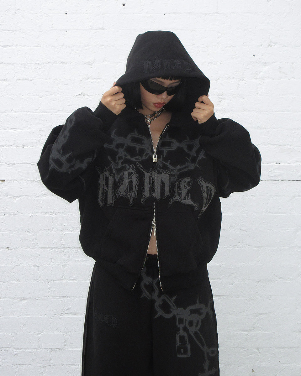 Chains zip hoodie black displayed on a model with black sunglasses and hood up.