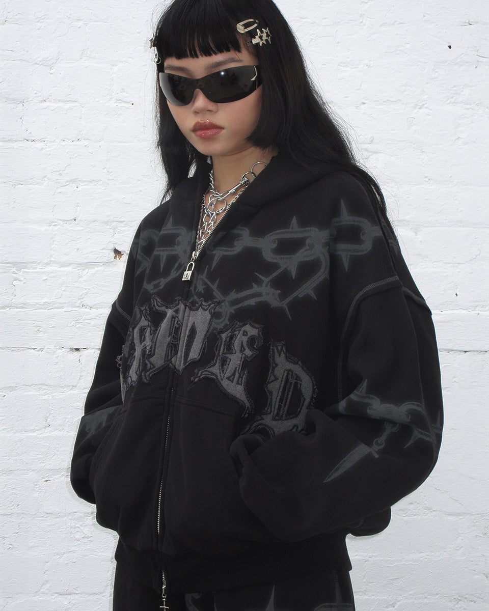 Model wearing Chains zip hoodie black and black sunglasses.