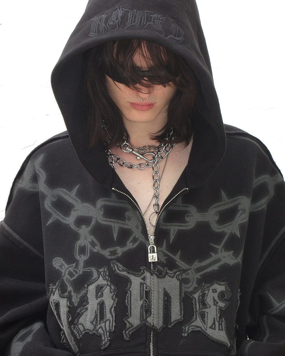Close of male model wearing Chains zip hoodie black with chain accessories.