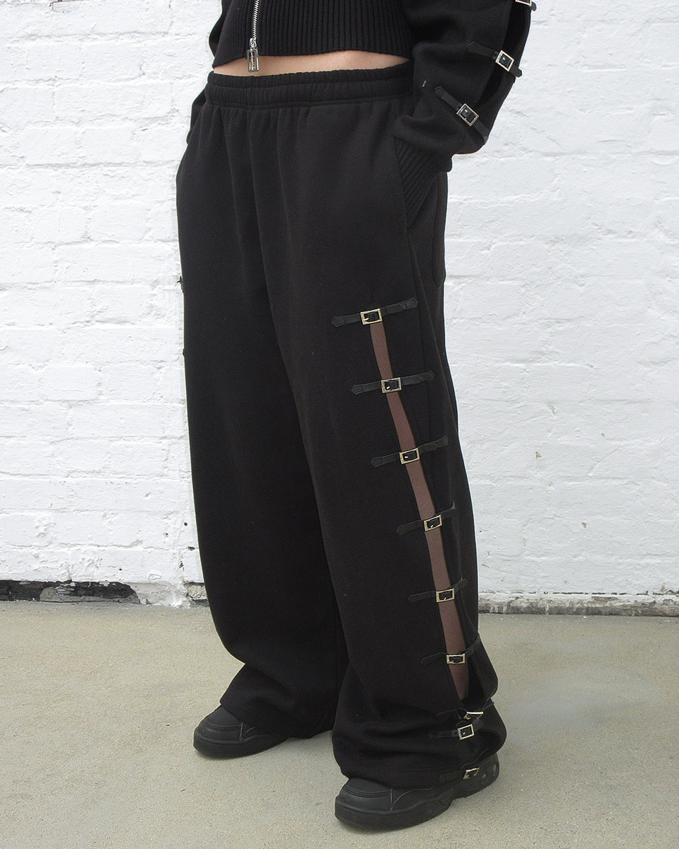 Crush buckle oversized sweatpants black worn on model, featuring buckle fastening design.