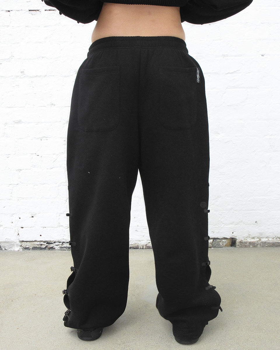 Crush buckle oversized sweatpants black showcased from the front with drawstring waistband.