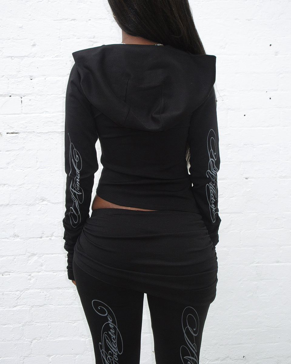 Back view of model wearing Crush sculpt stretch drape hoodie black.
