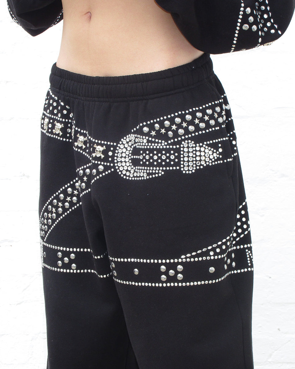 Close up view of Crush studded belt oversized sweatpants black.
