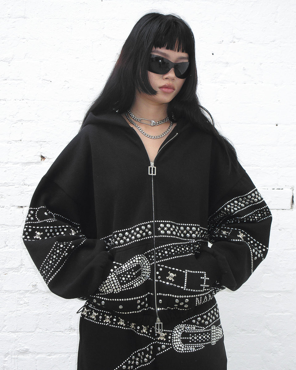 Crush studded belt zip hoodie black worn by model with black sunglasses.