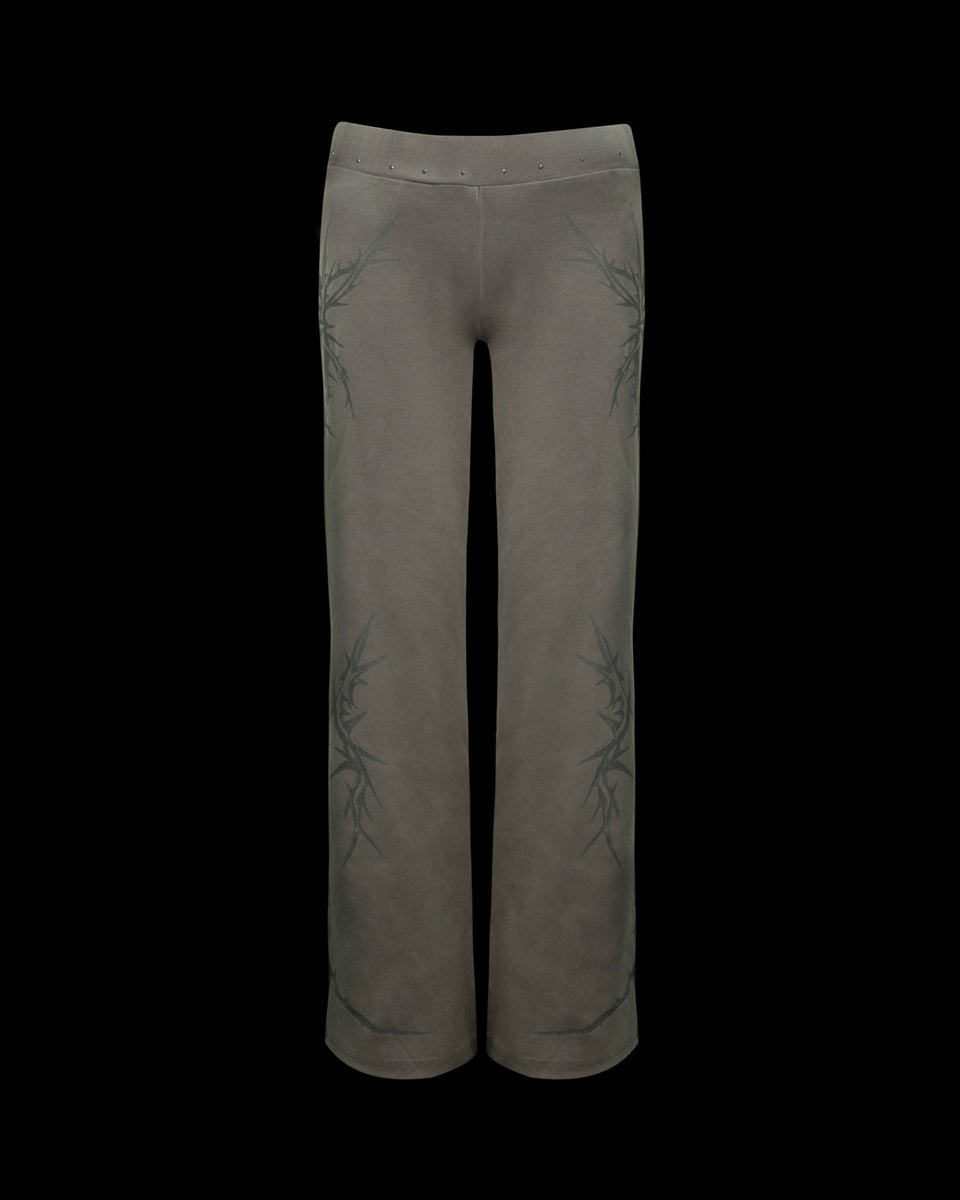 NAMED COLLECTIVE® CURSE SCULPT STRETCH PANTS in light washed army green with dark branch-like side patterns.