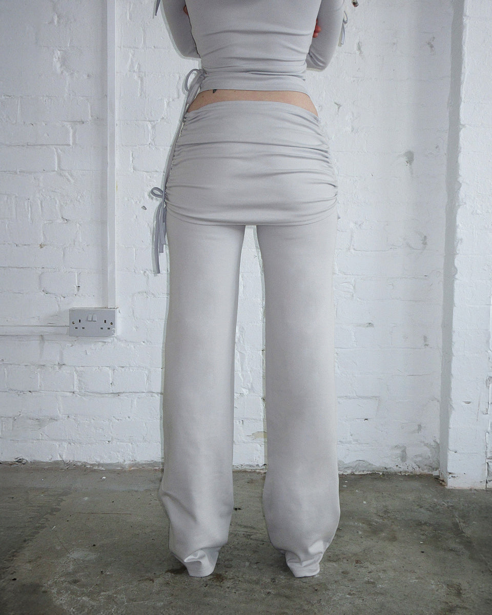 Person wearing NAMED COLLECTIVE® ENVY SCULPT Stretch Skirt Trouser Set in Mist Grey, back to camera.