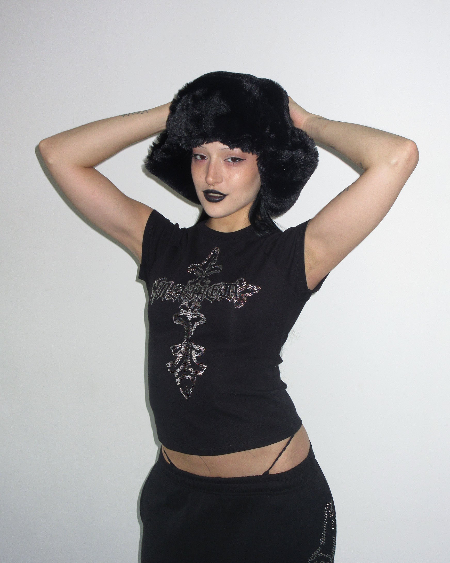 Model wears NAMED COLLECTIVE® FERAL STUDDED BABY TEE BLACK and poses against a plain white background.