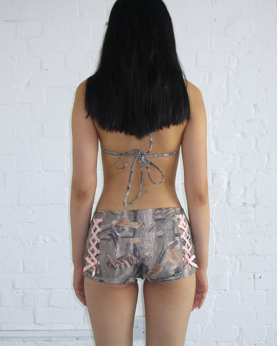 NAMED COLLECTIVE Forbidden Hotpant Shorts in Tree Camo with Baby Pink Satin Ribbon Lace, showcasing a trendy back view.