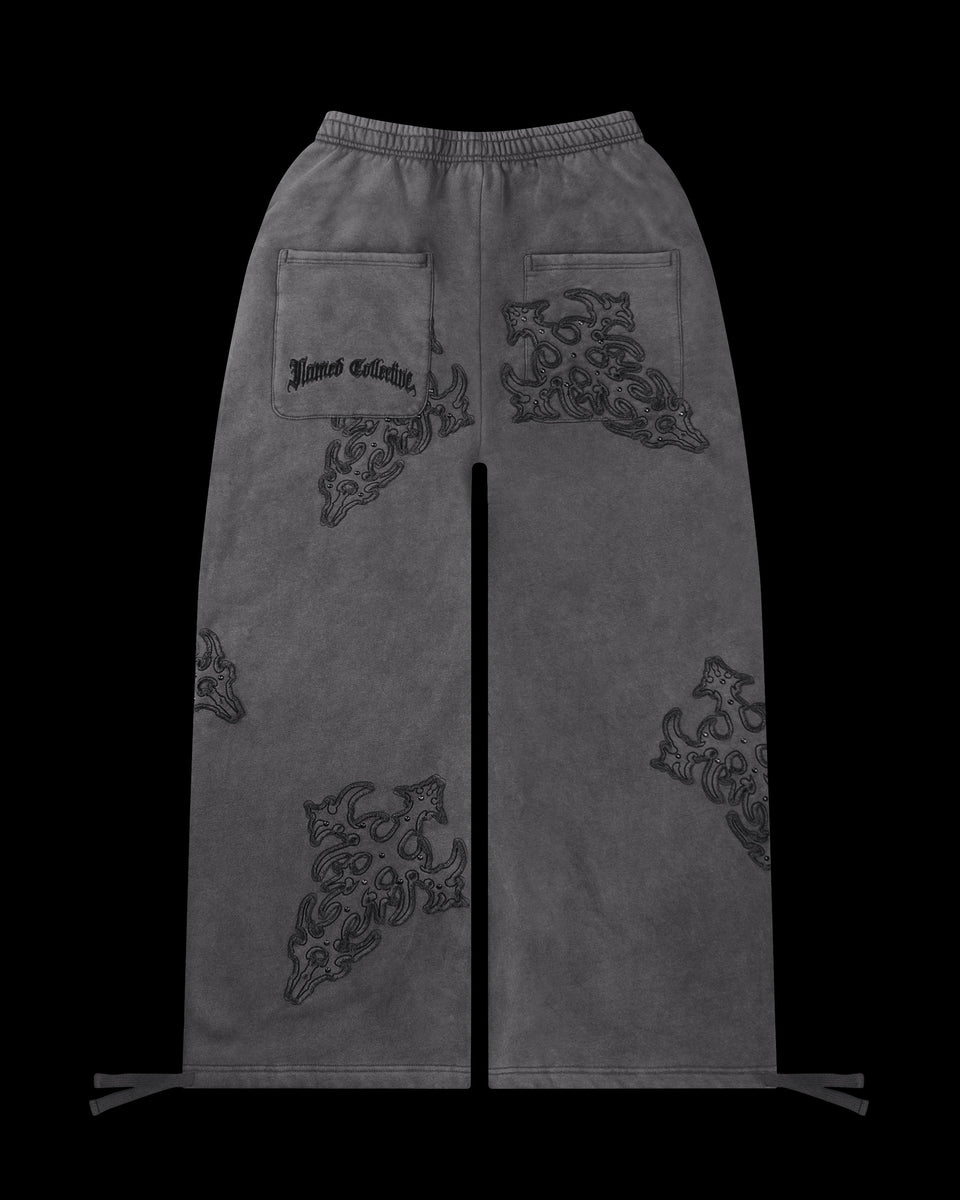 NAMED COLLECTIVE® SINNER Studded Oversized Grey Sweatpants with embroidered details and two back pockets.