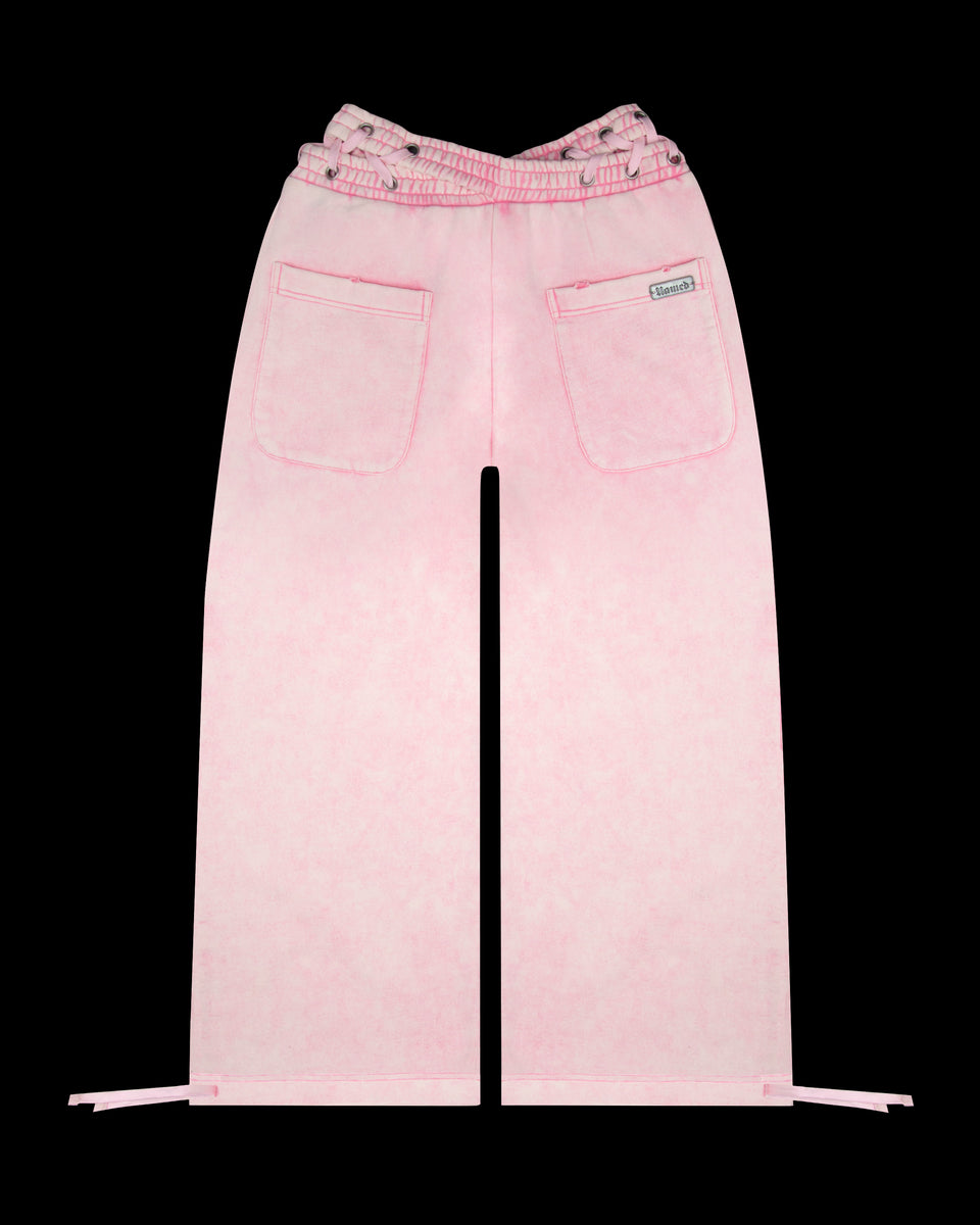 Vendetta oversized sweatpants in washed baby pink, featuring a cross-over waistband, made from organic cotton and recycled polyester.