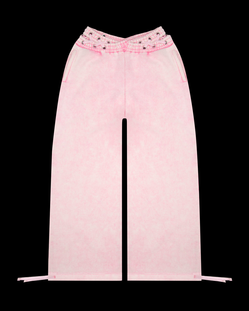 Vendetta oversized sweatpants in washed baby pink with cross-over waistband, made from organic cotton and recycled polyester fleece.