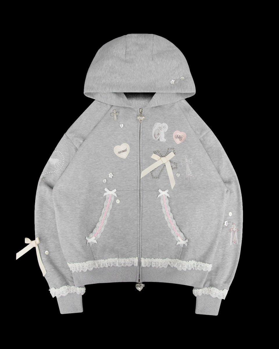 The NAMED COLLECTIVE® WHISPER ZIP HOODIE GREY MARL has lace trim, bows, and pastel embroidered patches.