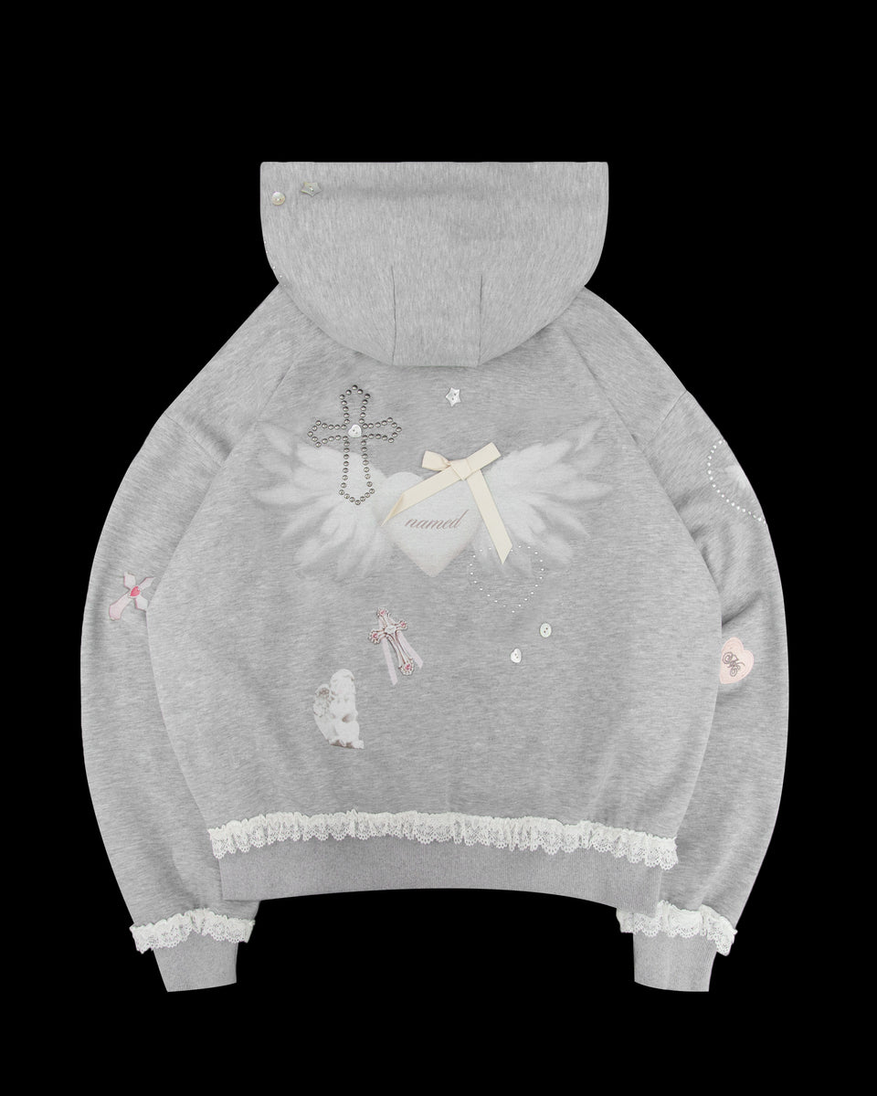 The NAMED COLLECTIVE® WHISPER ZIP HOODIE GREY MARL features lace trim, angel wings, a beaded cross, and patches.
